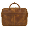 A brown vintage genuine leather briefcase with leather handles and a zipper closure.