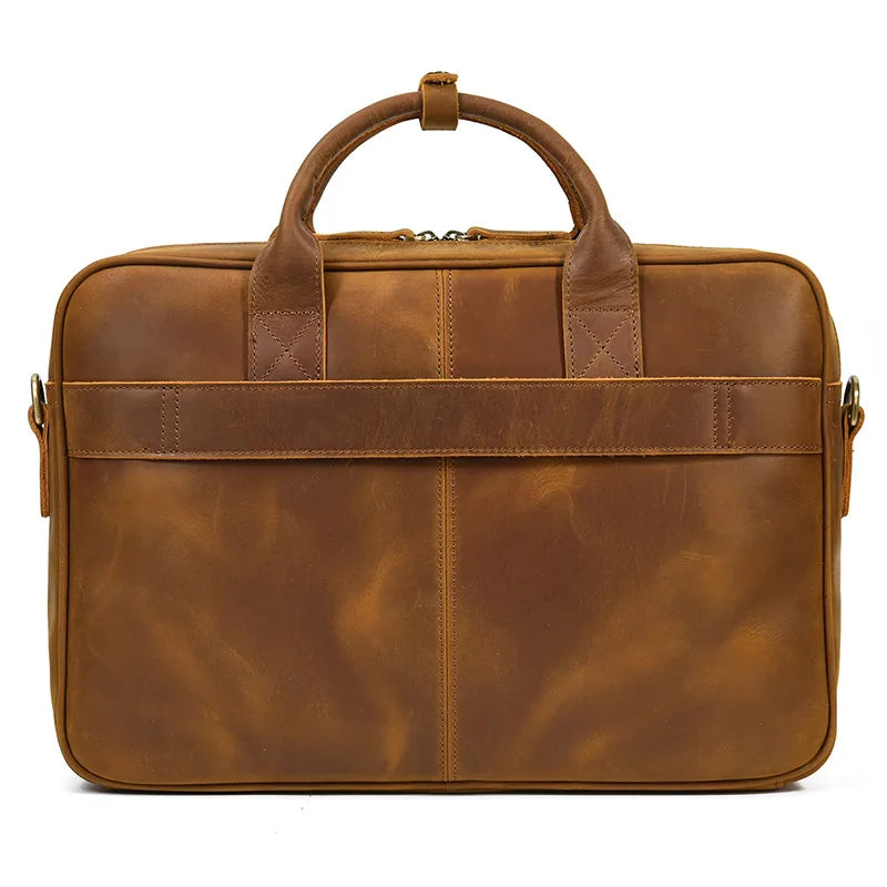 A brown vintage genuine leather briefcase with leather handles and a zipper closure.