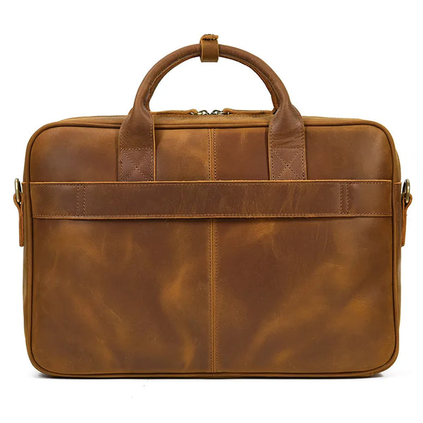 A brown vintage genuine leather briefcase with leather handles and a zipper closure.