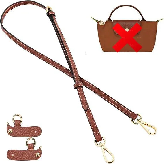 A brown leather crossbody strap with a decorative red cross buckle and attached to a small leather pouch.