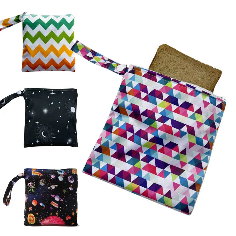 A collection of colorful reusable waterproof snack bags featuring geometric patterns and a brown canvas bag.