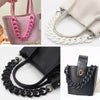 Black handbag with a chunky chain shoulder strap and a pink handbag with a white chain strap.