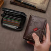 A hand holds a dark brown vintage PU leather slim wallet with gold accents and an RFID blocking feature.