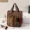 A clear waterproof travel toiletry bag with a brown and striped handle, showing various grooming products inside.