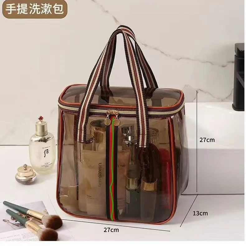 A clear waterproof travel toiletry bag with a brown and striped handle, showing various grooming products inside.