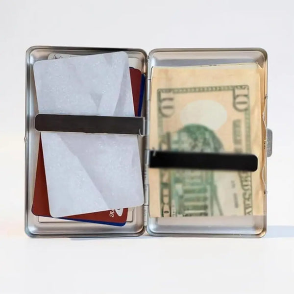 A vintage snap metal card holder containing several paper documents and a US dollar bill.