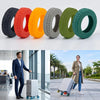 A set of eight colored rubber wheel protectors and a piece of silver travel luggage with wheels.