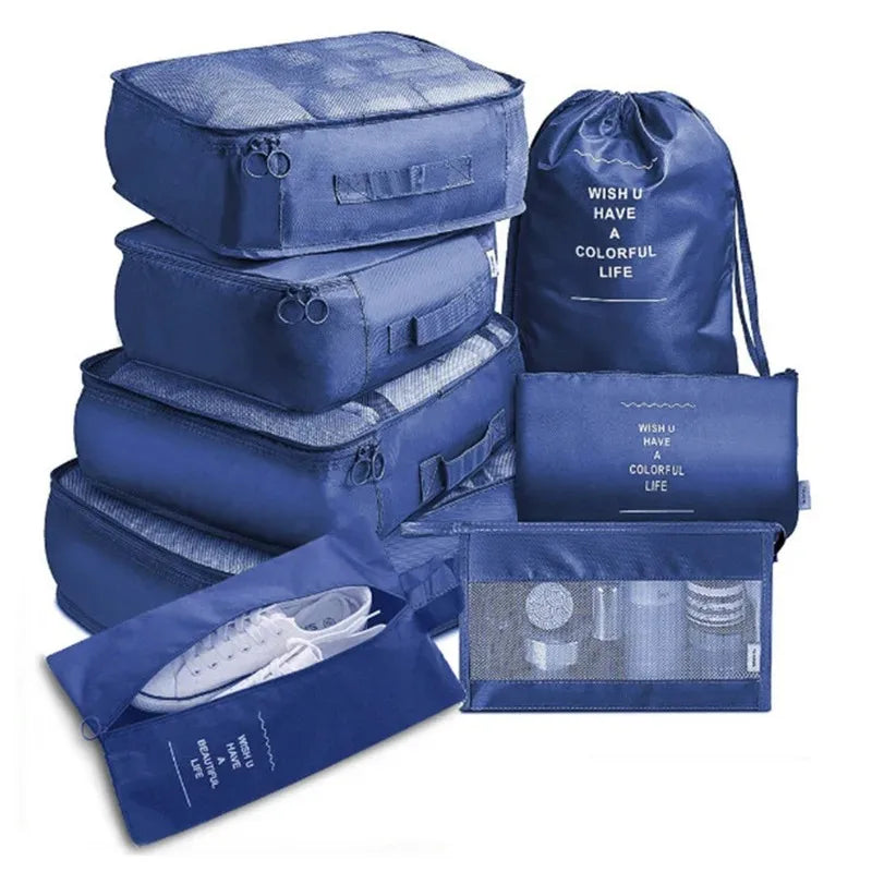 A stack of blue mesh packing cubes and a drawstring bag for travel organization.