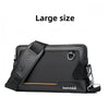 A large black leather crossbody bag with an adjustable strap and silver hardware.