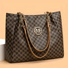 A dark brown geometric patterned tote bag with gold hardware and leather straps.