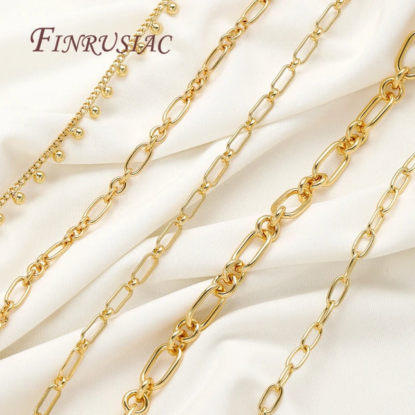 Multiple strands of 18K gold plated jewelry chains displayed on a white fabric background.
