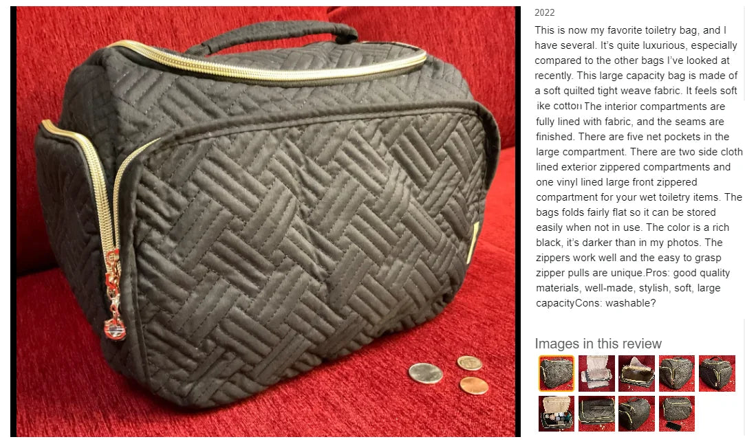 A dark quilted cosmetic organizer bag with a gold zipper and handle resting on a red fabric surface.