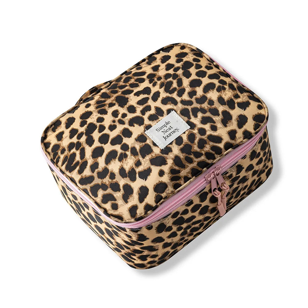 A leopard print large capacity waterproof travel makeup organizer bag with a pink zipper.