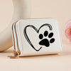 A white heart-shaped zipper wallet with a black paw print design resting on a light surface.