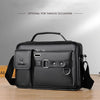 Black men's PU leather crossbody shoulder bag with a flap and strap shown on a wooden surface.
