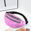 A pink holographic sequin waist bag with a black adjustable strap resting on a white surface.