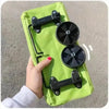A bright lime green foldable shopping cart with black handles and wheels is held by a hand.