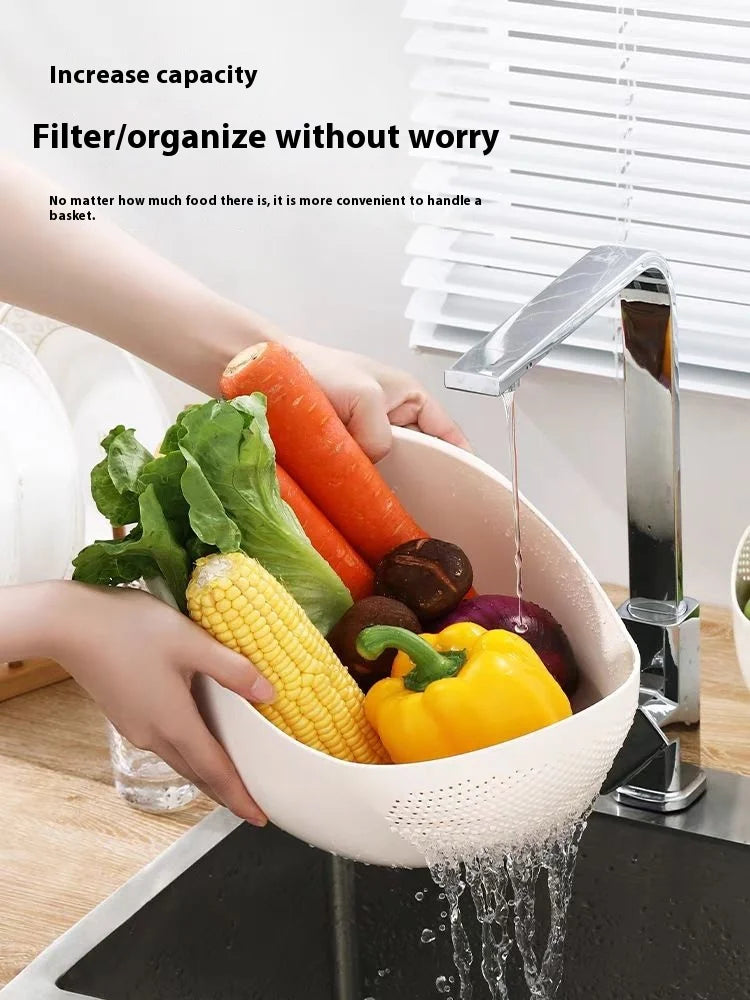 A hand is placing various colorful vegetables like carrots, corn, and bell peppers into a white plastic drain and storage bas