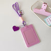 A pink PU credit card and ID holder keychain with a purple lanyard and a pink plastic holder on a white background.