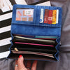 A blue leather clutch wallet is shown open, displaying various cards and cash inside.