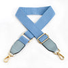 A light blue canvas cotton bag strap with gold-colored metal hooks, shown in an 'X' shape.