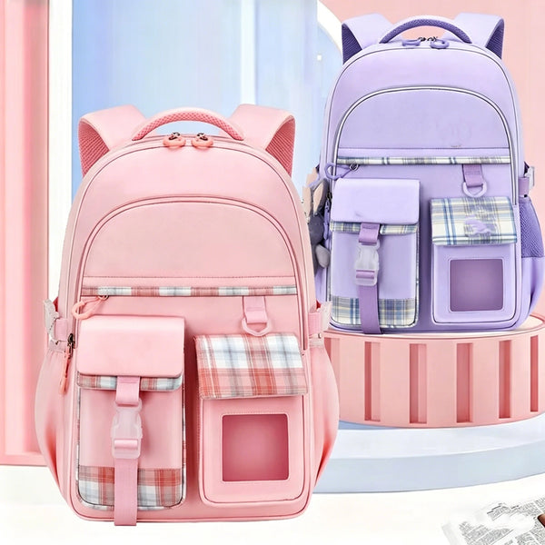 A pink lightweight children's school backpack with purple and plaid accents displayed on a white surface.