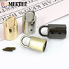 A collection of metal cord lock buckles in gold and silver finishes for bags, straps, and crafts.