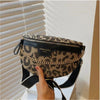 A leopard print crossbody shoulder bag with a black strap is shown against a white slatted blind.