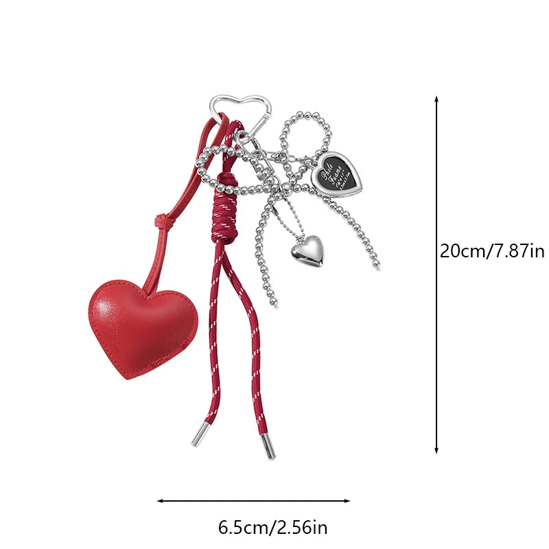 Red heart pendant key chain with silver chain and charm on a red ribbon