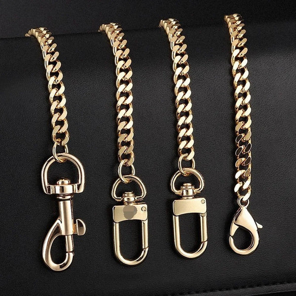 Four gold-colored adjustable metal chain handbag straps displayed on a dark surface.
