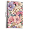 A metal card holder featuring a vibrant floral design with pink, purple, and cream blossoms.