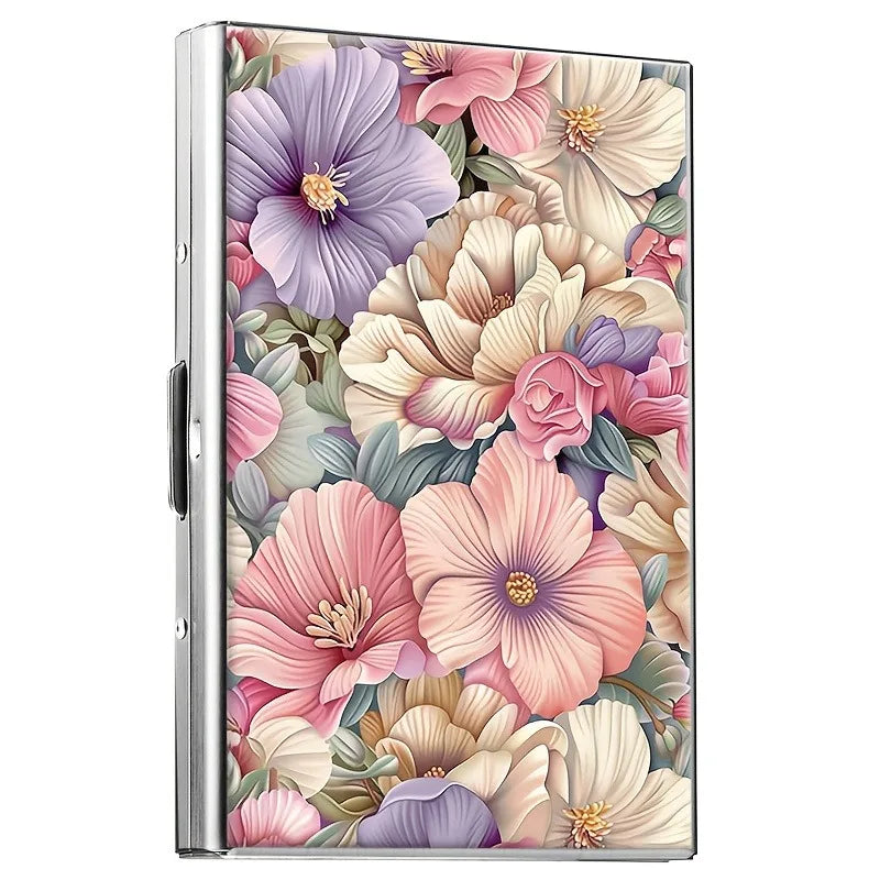 A metal card holder featuring a vibrant floral design with pink, purple, and cream blossoms.