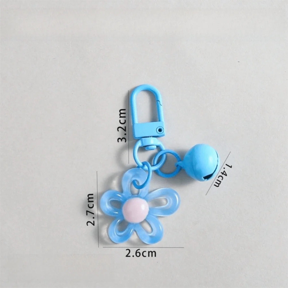 A light blue resin flower keychain attached to a silver-colored split ring.