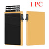 A gold-colored card holder with a black sleeve and an RFID blocking card slot, shown next to a stack of cards.