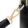 Close-up of a black PU leather trendy shoulder crossbody bag featuring a gold-toned chain and zipper detail.