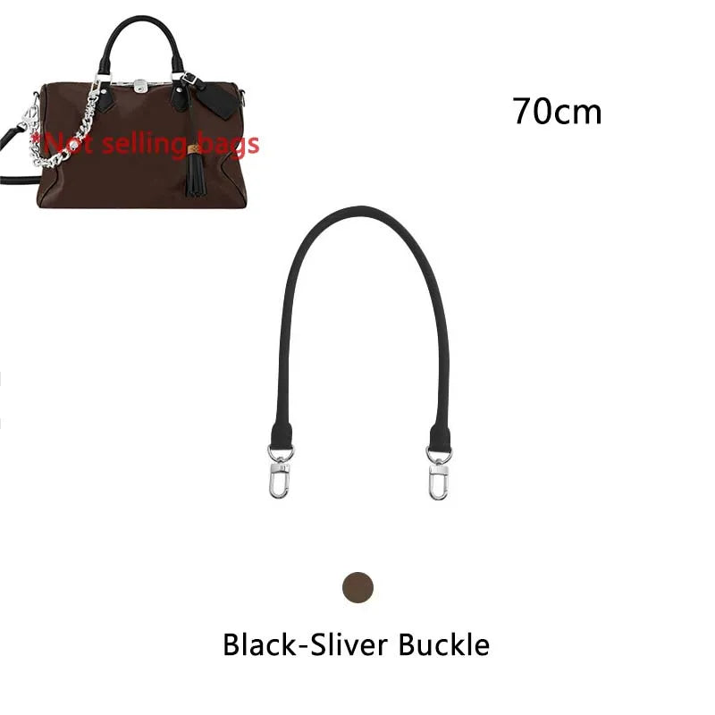 A brown leather handbag with a black strap and a silver buckle, shown next to a measurement scale.