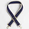 A navy blue and beige patterned adjustable crossbody bag strap with a gold buckle.