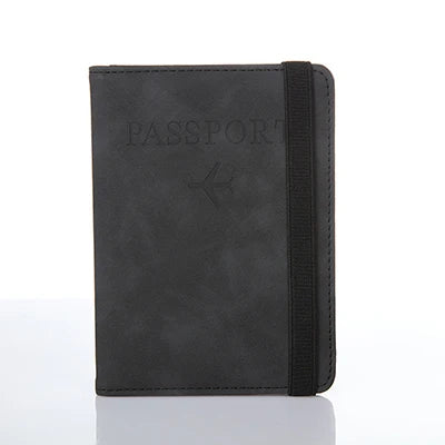 A black leather passport organizer with a slim design and a black strap.