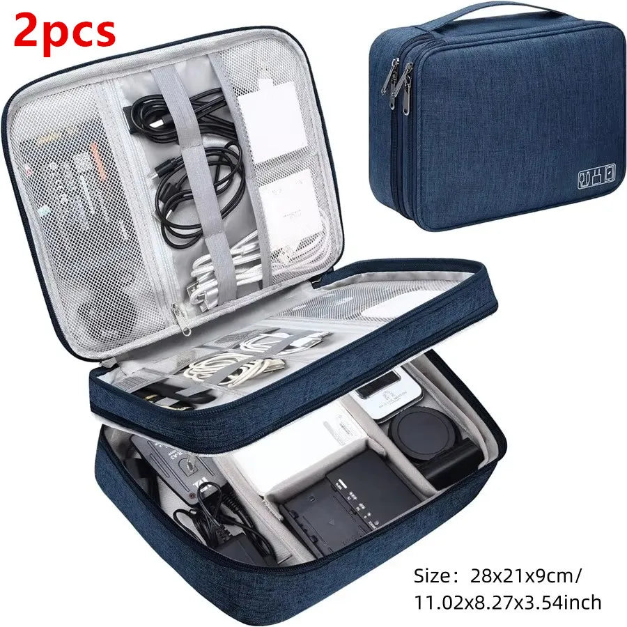 Two dark blue portable digital organizer storage pouches with zippered compartments and mesh pockets.