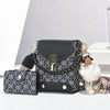 Un sac bandoulière en cuir faux noir avec des éléments dorés et un tissu à motifs, montré à côté d'une version plus petite.
