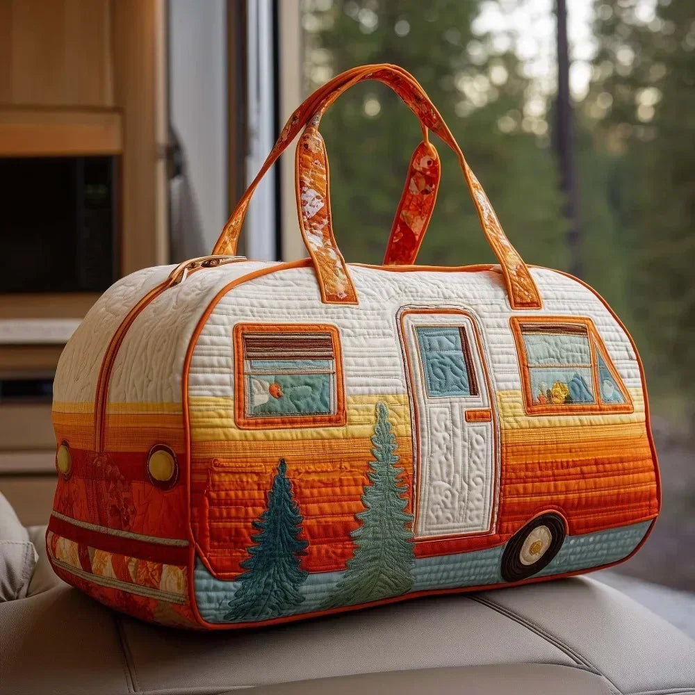 An orange and white quilted travel duffle bag with leather handles sitting on a light surface.