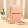 A pink leather crossbody bag with gold hardware resting on a light wooden surface next to a potted succulent.
