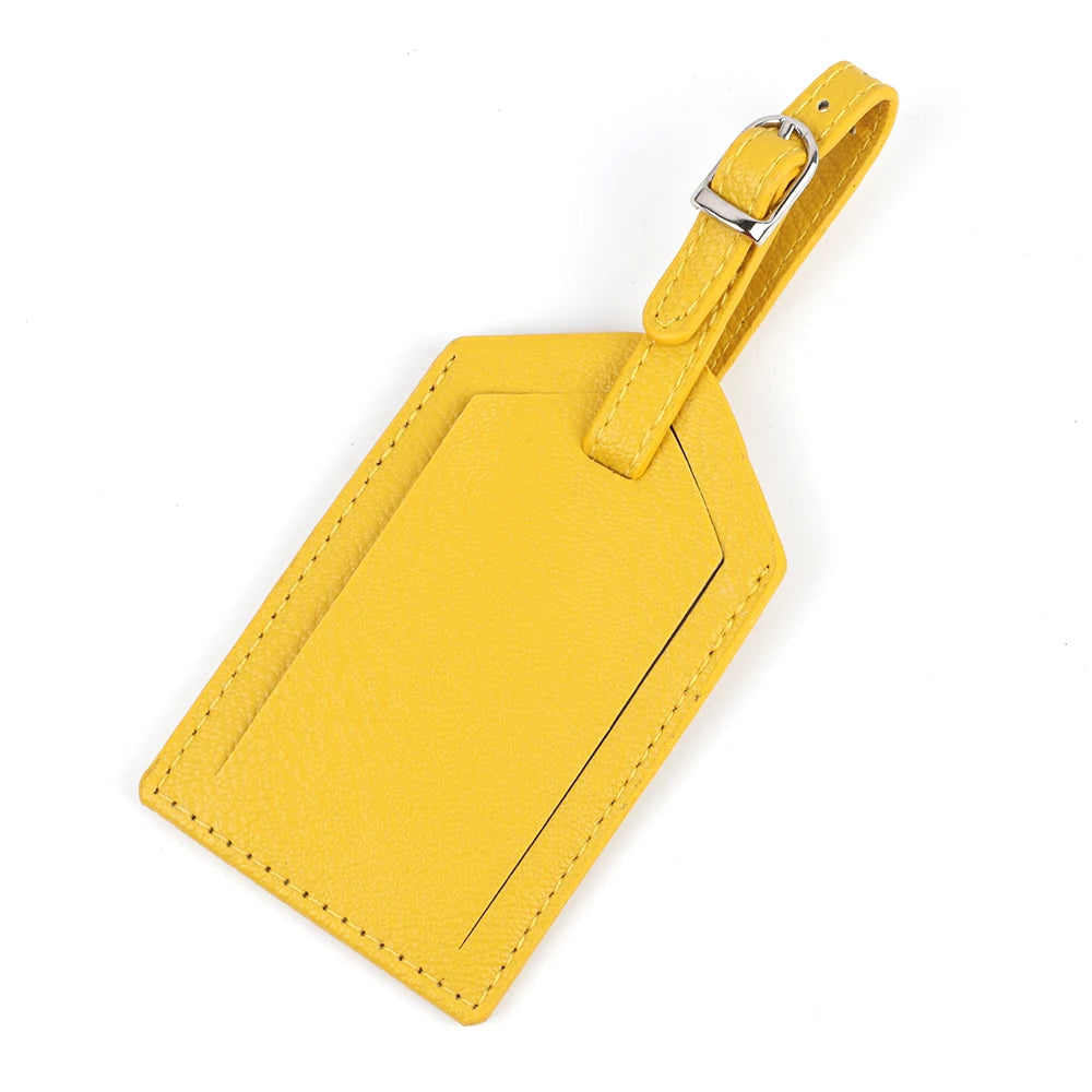 A yellow PU leather luggage tag with a gold-toned clip attached.