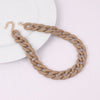 A gold-plated chain necklace with a braided texture in a beige color displayed on a white background.