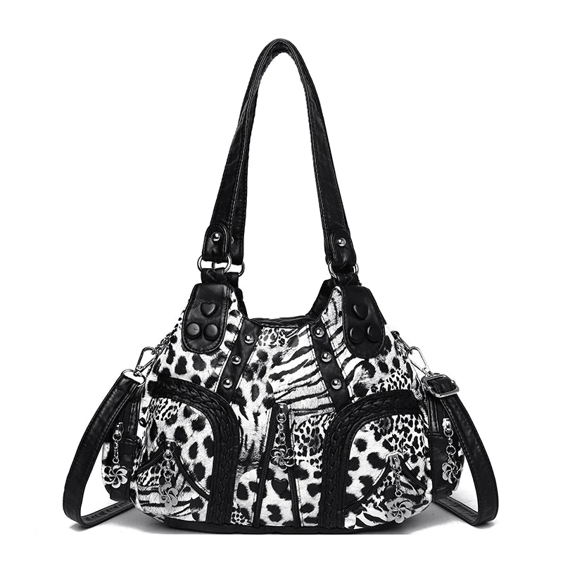 A black and white leopard print PU leather tote bag with a black adjustable strap.