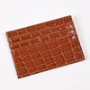 A brown crocodile pattern slim card holder wallet made of leather.