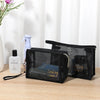 Black mesh travel cosmetic storage pouch with a lid and a bottle of liquid inside