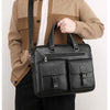 A man wearing a beige sweater and black pants holds a black PU leather business briefcase bag.
