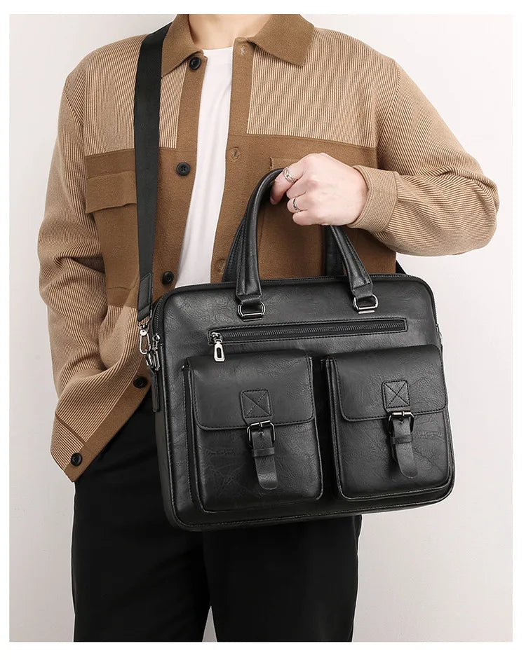 A man wearing a beige sweater and black pants holds a black PU leather business briefcase bag.