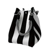 A black and white striped knit bucket tote bag with silver hardware.